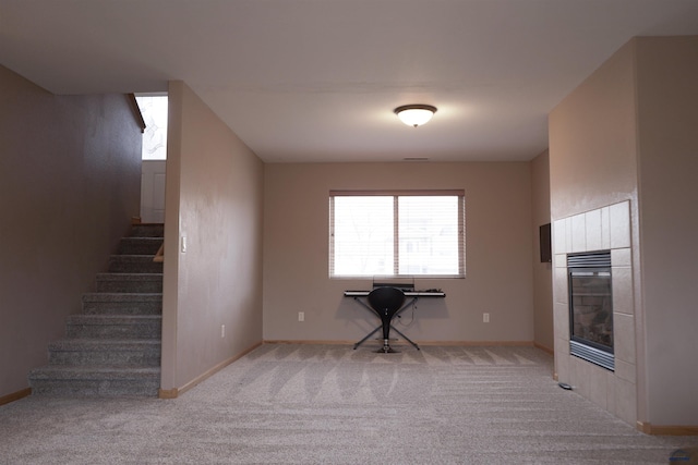 unfurnished living room with light colored carpet and a fireplace