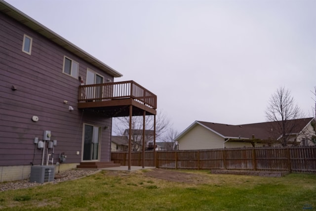 view of yard featuring a deck and central AC