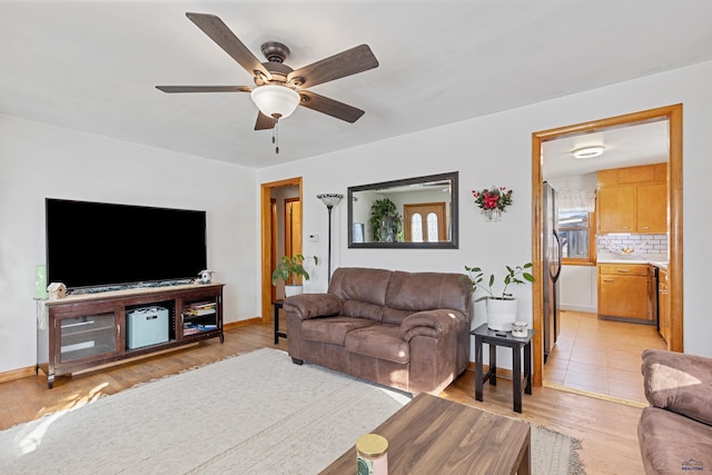 living room with ceiling fan and light hardwood / wood-style floors