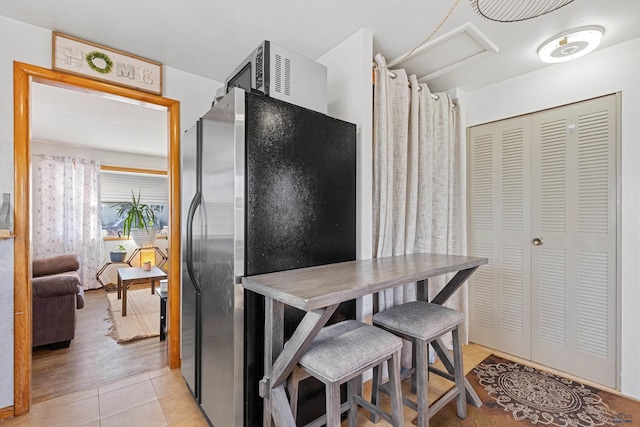 1002 Allen Ave, Rapid City, SD 57701 - kitchen with light tile patterned flooring and stainless steel refrigerator