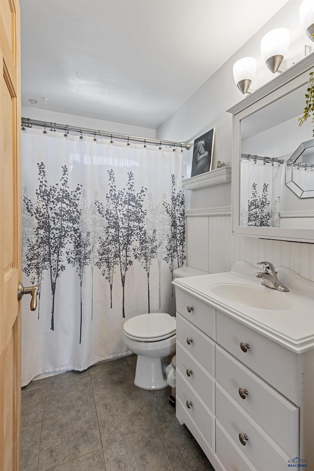 1002 Allen Ave, Rapid City, SD 57701 - bathroom with tile patterned floors, toilet, and vanity