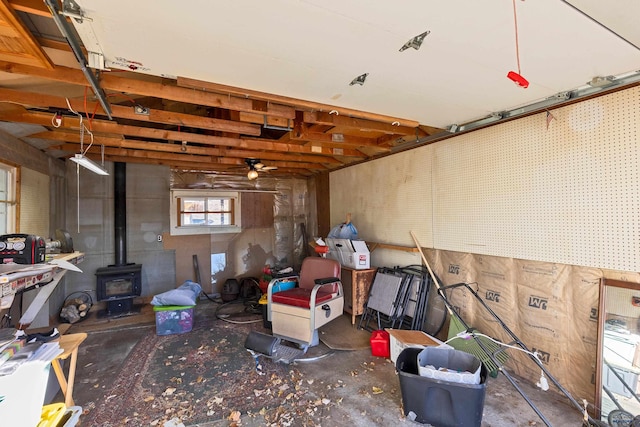 1002 Allen Ave, Rapid City, SD 57701 - basement featuring ceiling fan and a wood stove