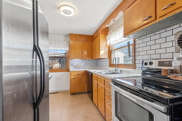 1002 Allen Ave, Rapid City, SD 57701 - kitchen featuring sink, light tile patterned floors, stainless steel appliances, and tasteful backsplash