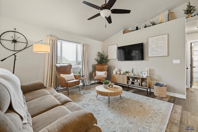 living room with ceiling fan, vaulted ceiling, and dark hardwood / wood-style floors