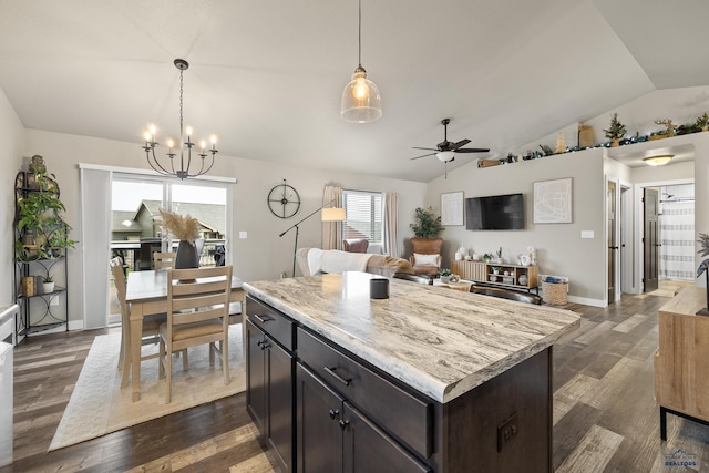 kitchen with ceiling fan with notable chandelier, a center island, lofted ceiling, dark hardwood / wood-style flooring, and hanging light fixtures