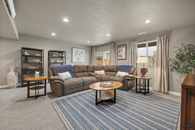 carpeted living room featuring a textured ceiling