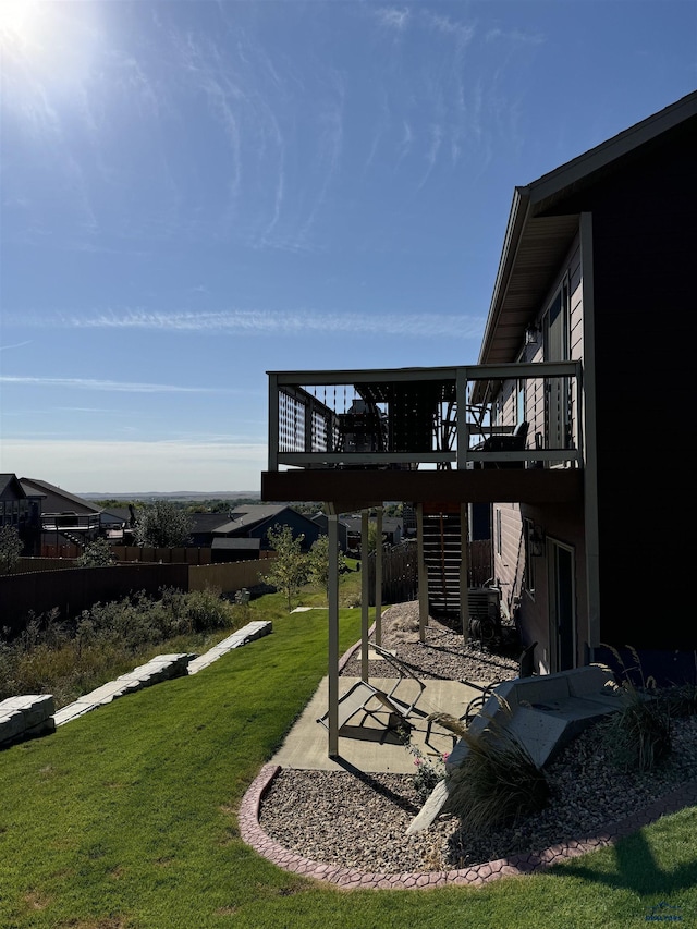 view of yard with a wooden deck and a patio