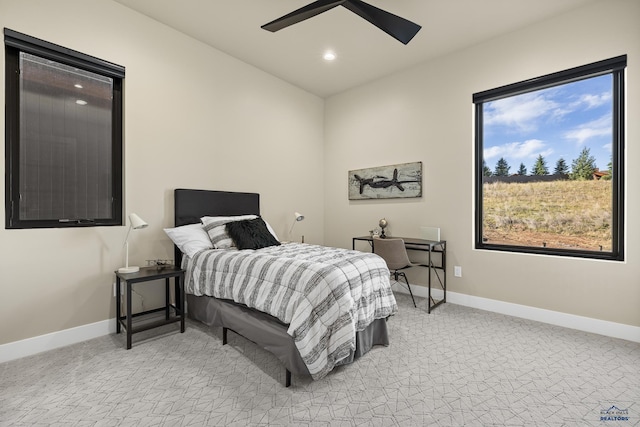 bedroom with ceiling fan and light carpet