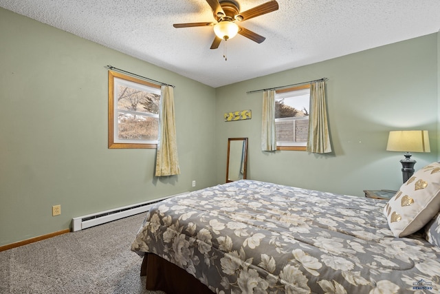 bedroom with ceiling fan, a baseboard heating unit, carpet floors, and a textured ceiling