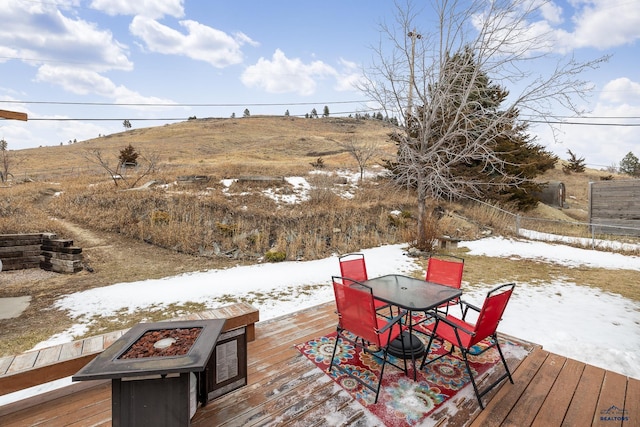 snow covered deck with an outdoor fire pit