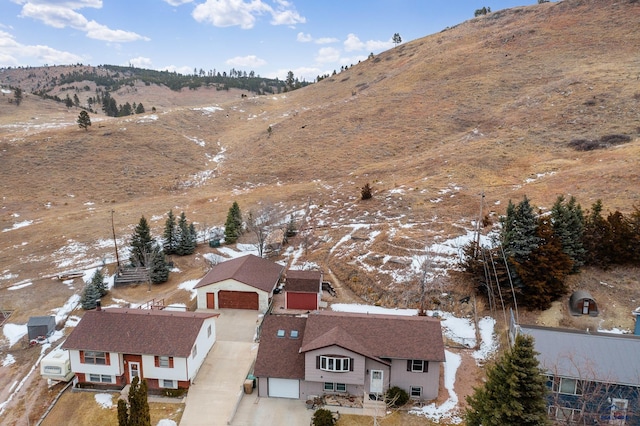 snowy aerial view featuring a mountain view