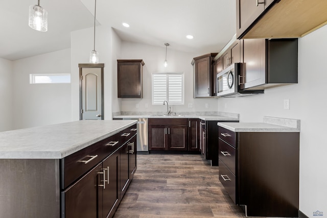 kitchen featuring sink, hanging light fixtures, appliances with stainless steel finishes, and lofted ceiling