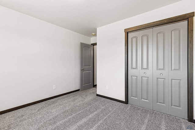 unfurnished bedroom with carpet floors and a closet