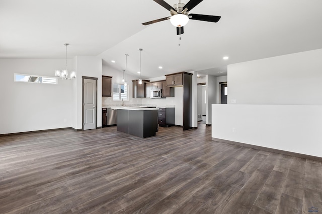 kitchen featuring pendant lighting, a center island, lofted ceiling, stainless steel appliances, and dark hardwood / wood-style floors