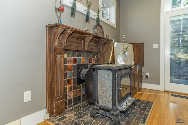 room details featuring a wood stove and hardwood / wood-style floors