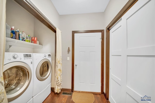 washroom featuring washer and clothes dryer and dark hardwood / wood-style flooring