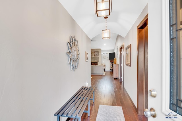 hall with dark wood-type flooring and lofted ceiling