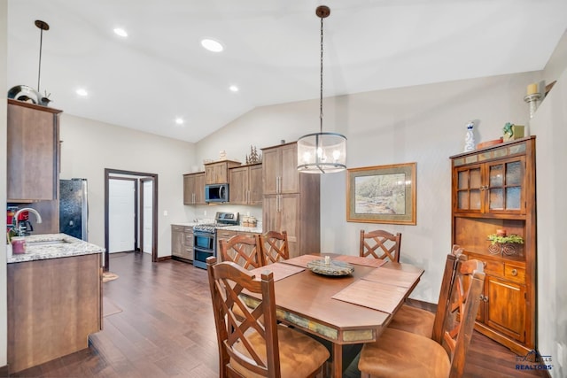 dining space with sink, dark hardwood / wood-style flooring, an inviting chandelier, and vaulted ceiling