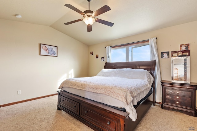 bedroom with vaulted ceiling, light colored carpet, and ceiling fan