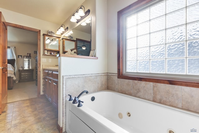 bathroom with vanity, a washtub, and tile patterned floors