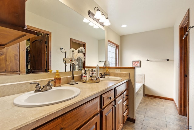 bathroom featuring vanity, tile patterned flooring, and a tub