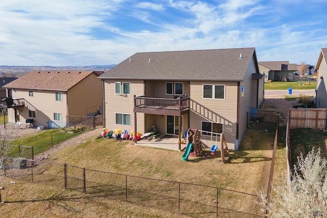 rear view of house with a playground, a yard, and a patio area