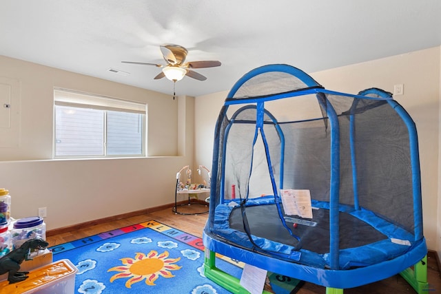 rec room with hardwood / wood-style flooring and ceiling fan