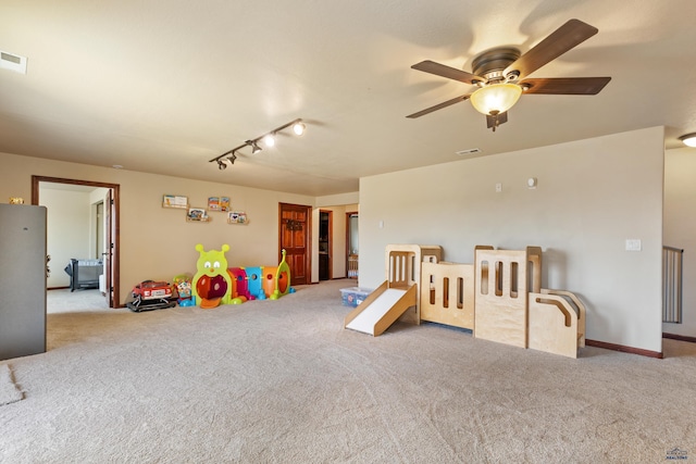 game room with light carpet and ceiling fan