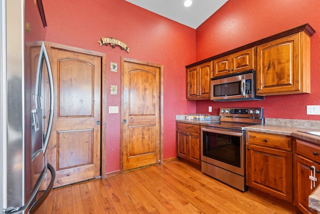 kitchen featuring appliances with stainless steel finishes and light hardwood / wood-style floors