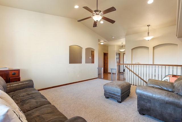 living room with high vaulted ceiling, ceiling fan, and carpet flooring