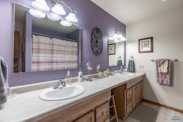 bathroom with tile patterned flooring, a shower with curtain, and vanity