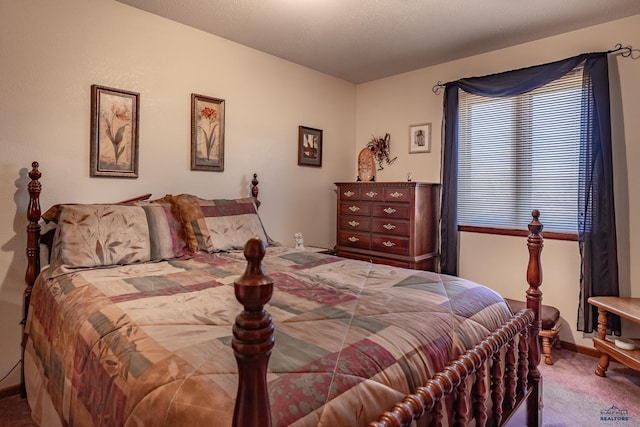 bedroom featuring a textured ceiling and carpet flooring