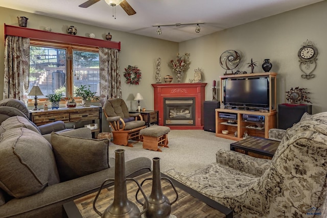 carpeted living room featuring ceiling fan and track lighting