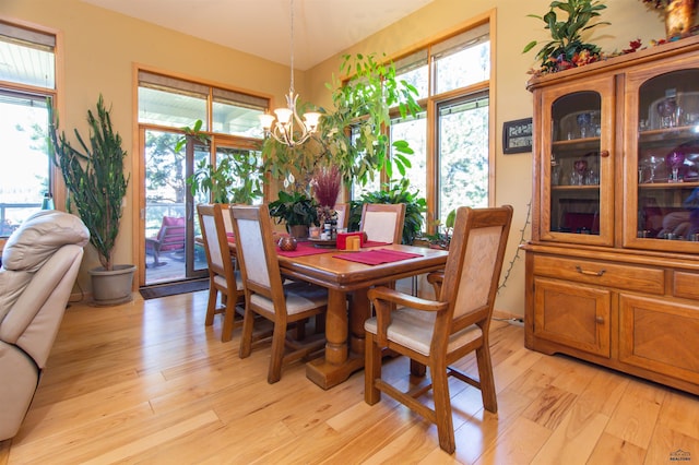 dining area featuring light hardwood / wood-style floors and an inviting chandelier