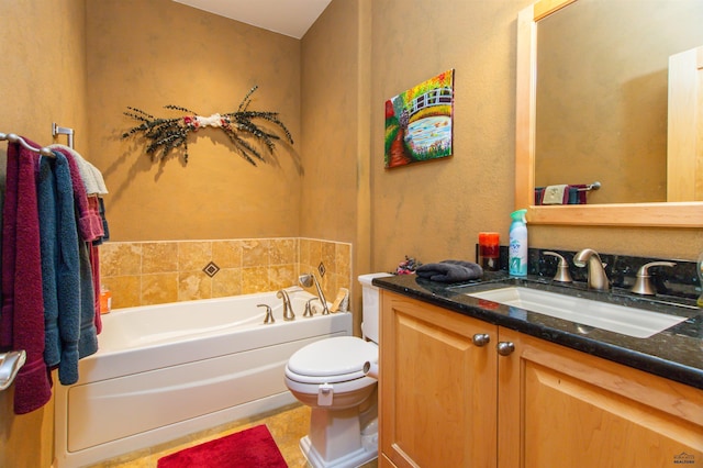 bathroom with toilet, vanity, and a bathtub