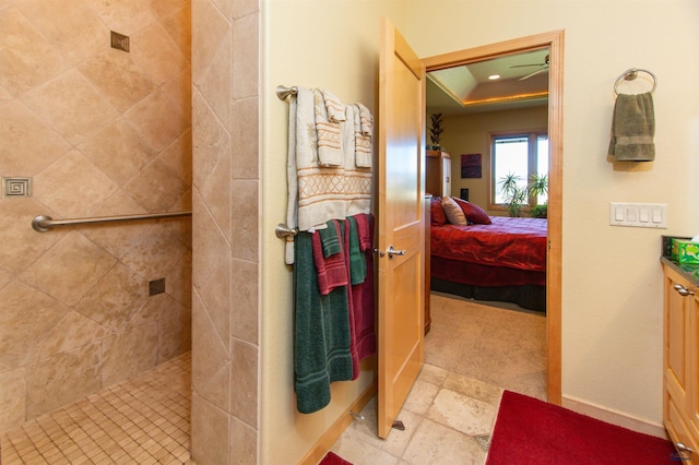 bathroom with tiled shower and vanity