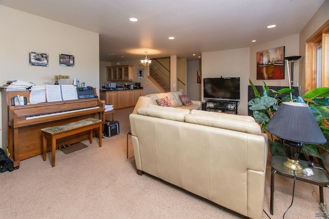 living room with light colored carpet and a notable chandelier