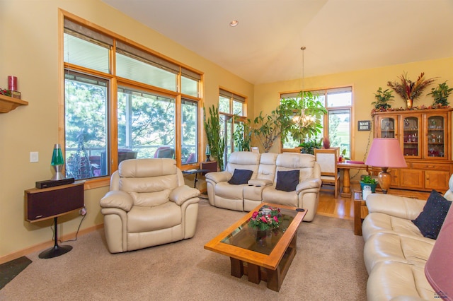 living room featuring light colored carpet and a notable chandelier