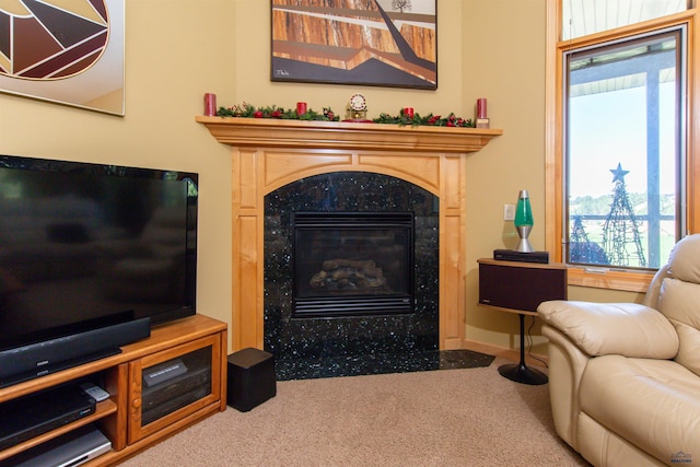 carpeted living room featuring a premium fireplace