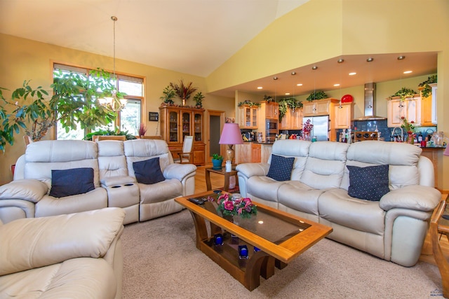 living room featuring a notable chandelier and vaulted ceiling