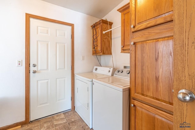 laundry room featuring cabinets and washer and clothes dryer