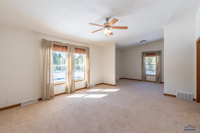 carpeted empty room featuring ceiling fan and lofted ceiling