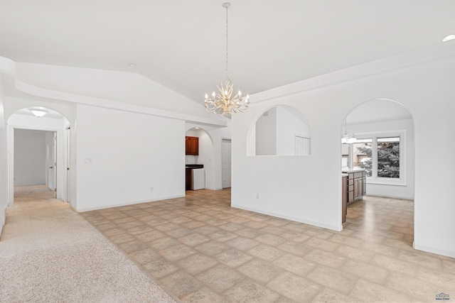 empty room featuring an inviting chandelier and vaulted ceiling