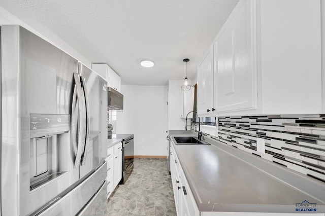 kitchen featuring electric range oven, pendant lighting, white cabinetry, sink, and stainless steel fridge with ice dispenser