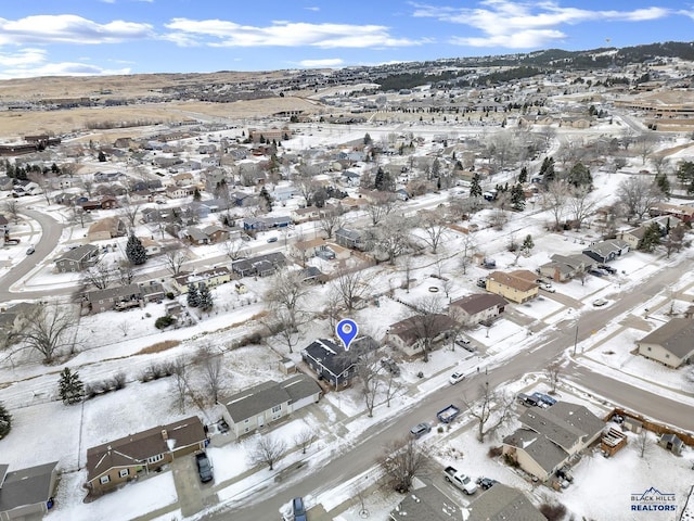 snowy aerial view with a mountain view