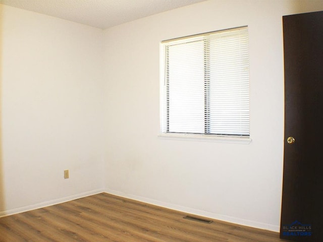 unfurnished room featuring wood-type flooring