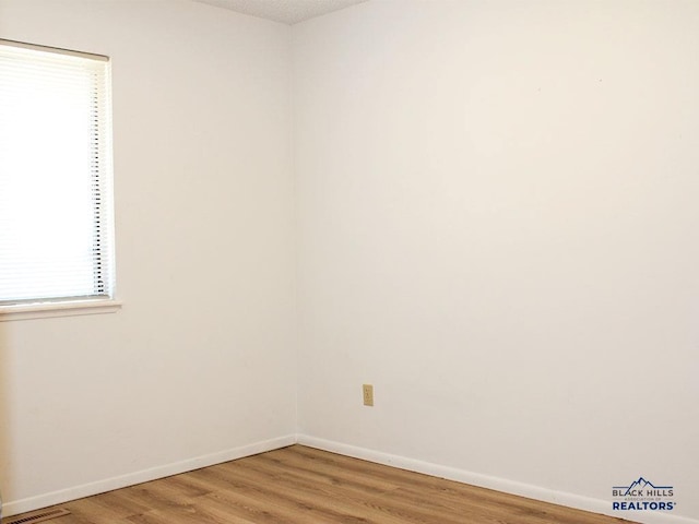 empty room featuring hardwood / wood-style flooring