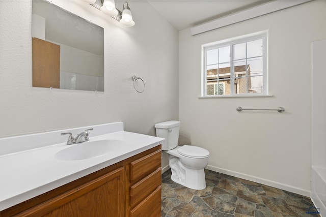 bathroom with vanity, toilet, and walk in shower