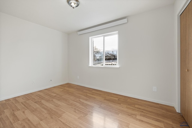 unfurnished bedroom with light hardwood / wood-style flooring and a closet