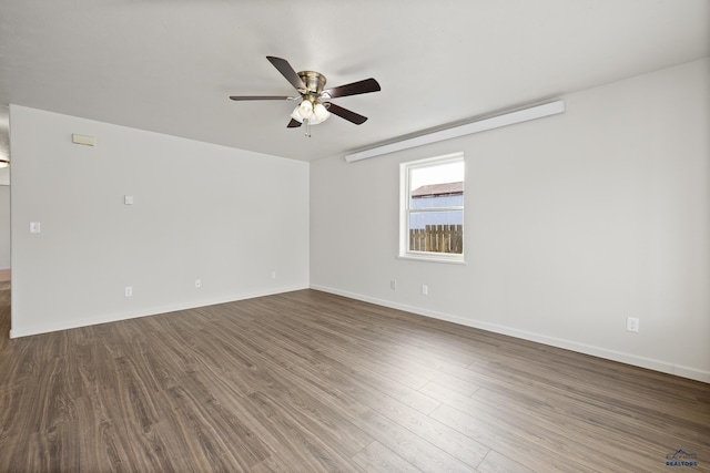 empty room featuring ceiling fan and dark hardwood / wood-style floors